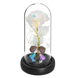 Glass dome rose shown from above with battery compartment visible in the wooden base