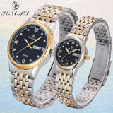 Two-tone silver and gold couple watches with black dial on light blue background