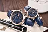Close-up of rose gold couple watches with blue dial and blue leather straps