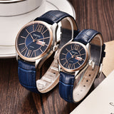 Rose gold case couple watches with blue dial and blue leather straps coiled together