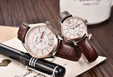 Rose gold case couple watches with white dial and brown leather straps shown at an angle