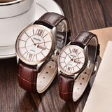 Rose gold case couple watches with white dial and brown leather straps coiled together