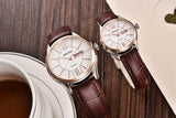 Rose gold case couple watches with white dial and brown leather straps on wood surface